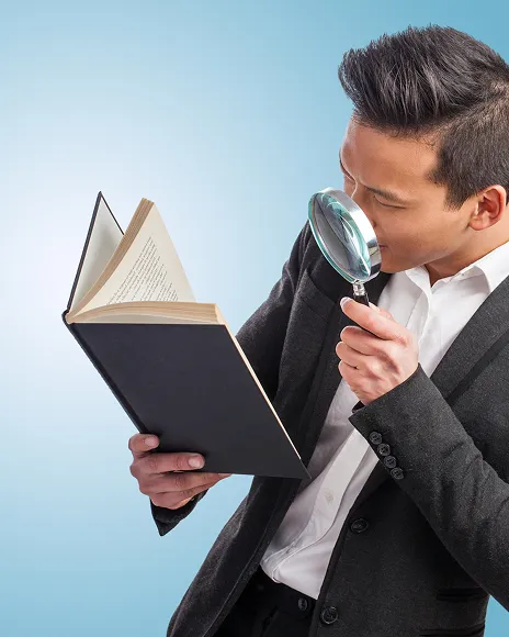 Man examining a book through a magnifying glass, representing Wikipedia source standards