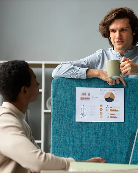 Colleagues discussing a chart in a bright office, representing neutral, well-sourced writing