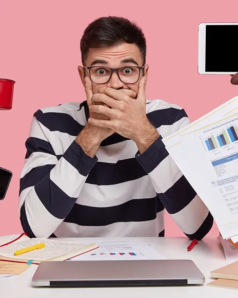 Man covering his mouth in surprise at a laptop, representing negative page-one results
