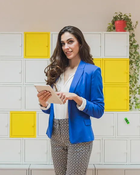 Woman in a blue blazer holding a tablet, representing executive personal branding
