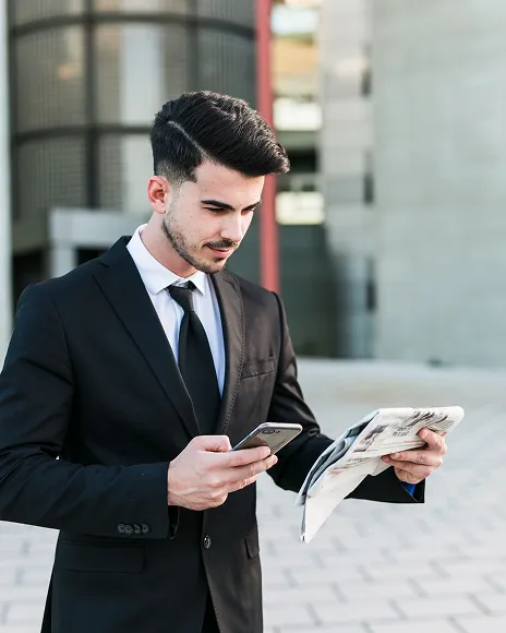 Businessman reading a magazine feature outdoors