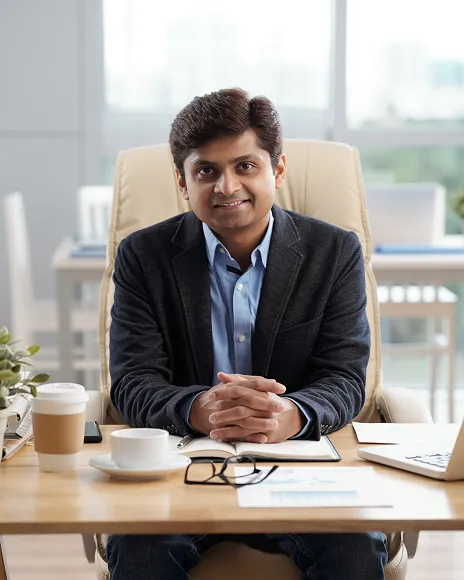 Consultant seated at a desk in a modern office, representing professional authority