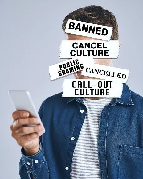 Man holding a phone beneath BANNED and cancel culture labels, representing platform rule violations