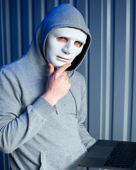 Man in a white mask and hoodie, representing a fake profile