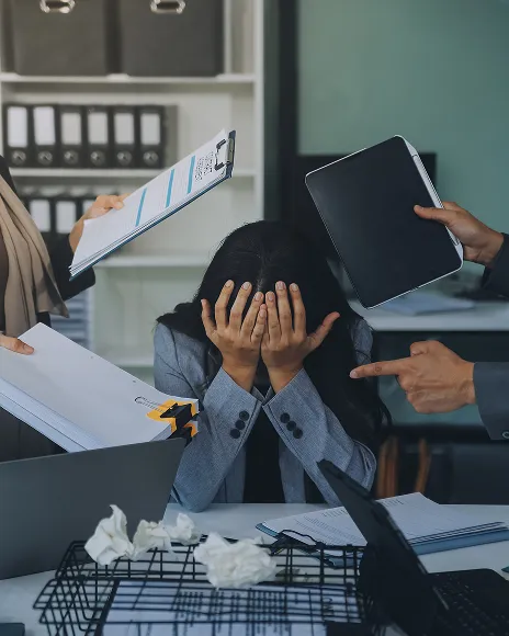 Distressed person with head in hands, representing online harassment