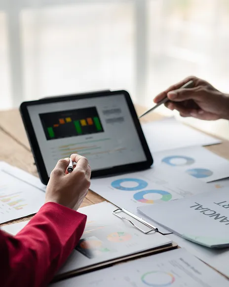 Hands working on a tablet with charts, representing digital activity analysis