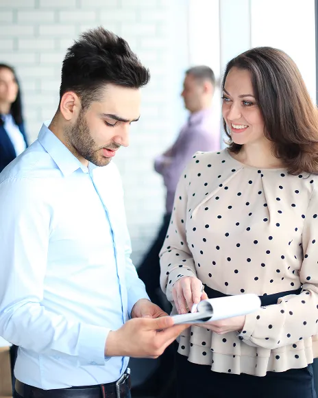 Two people reviewing a document, representing mapping links between accounts